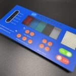 Technical diagram of a tactile membrane switch showing internal layers such as graphic overlay, metal dome, spacer, and bottom circuit layer, used to explain switch mechanics and design structure